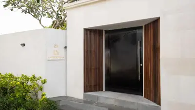 a black door on the side of a building at Villa Latima by Villa Finder in Seminyak