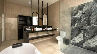 a bathroom with a shower and a sink and a toilet at Villa Latima by Villa Finder in Seminyak