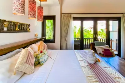 a bedroom with a large white bed and a balcony at Chandani 3 BR Private Pool Villa in Ujung