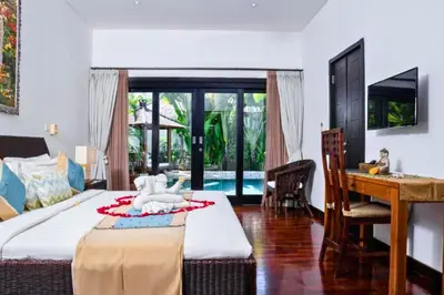 a bedroom with a bed and a table and a desk at Chandani 3 BR Private Pool Villa in Ujung