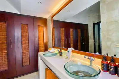 a bathroom with two sinks and a large mirror at Chetana 2 BR Private Pool Villa in Ujung