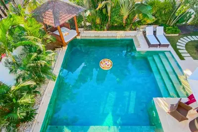 an overhead view of a swimming pool with a pizza in it at Chetana 2 BR Private Pool Villa in Ujung