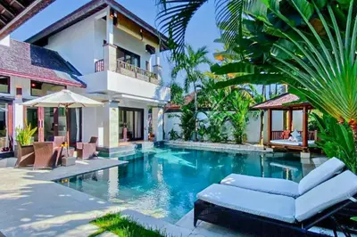a swimming pool in front of a villa at Chetana 2 BR Private Pool Villa in Ujung