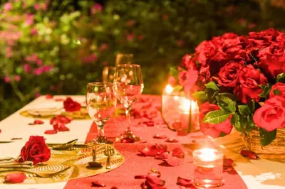 a table with wine glasses and a vase of roses at Chetana 2 BR Private Pool Villa in Ujung
