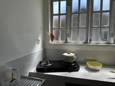 a kitchen with a stove and a pot on a burner at Cottage House Jimbaran in Jimbaran