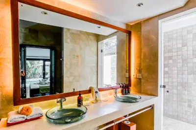 a bathroom with two sinks and a large mirror at Charvi 1 BR Private Pool Villa in Ujung
