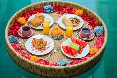 a table with plates of food on a table at Charvi 1 BR Private Pool Villa in Ujung
