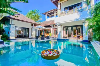 a villa with a swimming pool in front of a house at Charvi 1 BR Private Pool Villa in Ujung