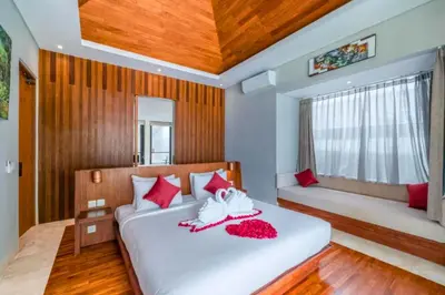 a bedroom with two beds with red pillows at Chayanika 4 BR Private Pool Villa With Sea View in Ujung