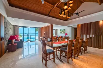 a dining room and living room with a table and chairs at Chayanika 4 BR Private Pool Villa With Sea View in Ujung