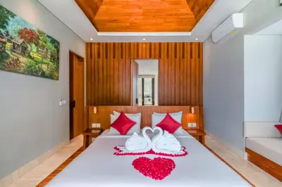 a bedroom with a bed with two hearts on it at Chayanika 4 BR Private Pool Villa With Sea View in Ujung