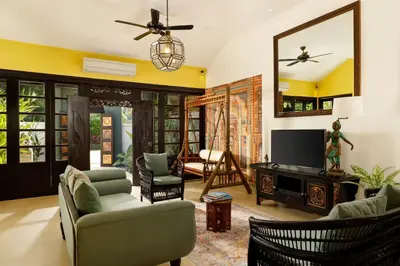 a living room with a couch and a tv at Shanti Estate Seminyak by Nakula in Seminyak
