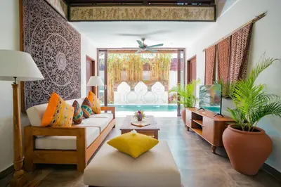 a living room with a couch and a fish tank at Shanti Estate Seminyak by Nakula in Seminyak