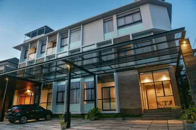 a building with a car parked in front of it at MINI Coliving Apartment in Seminyak