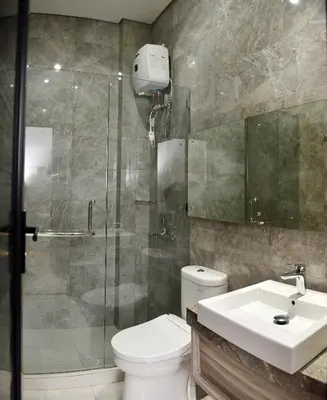 a bathroom with a shower and a toilet and a sink at MINI Coliving Apartment in Seminyak