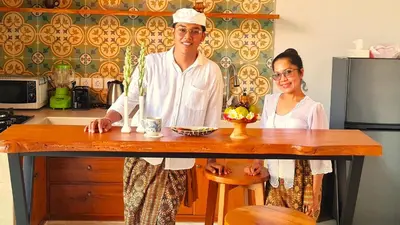 a man and a woman standing at a table in a kitchen at Sarayu Villa 2 - Serene and peaceful 2BR private Villa in Seminyak