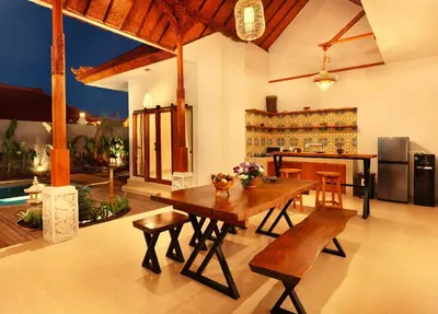 a living room with a wooden table and chairs at Sarayu Villa 2 - Serene and peaceful 2BR private Villa in Seminyak