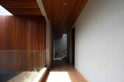 a hallway of a house with a wooden ceiling at ALENY Vila by VoLa in Seminyak
