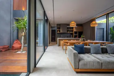 an open living room with a couch and a kitchen at ALENY Vila by VoLa in Seminyak