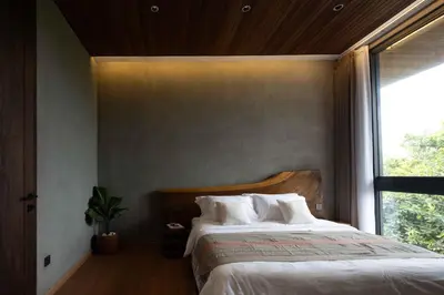 a bedroom with a bed with white sheets and a window at ALENY Vila by VoLa in Seminyak