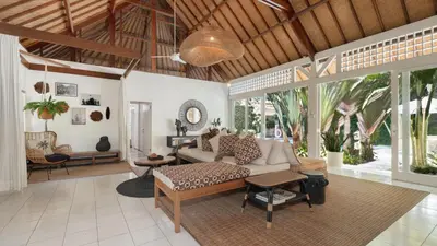 a living room with a couch and a table at Villa Celeste by Villa Finder in Seminyak
