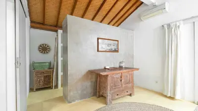 a bathroom with a wooden table in a room at Villa Celeste by Villa Finder in Seminyak