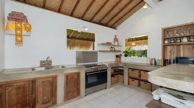 a kitchen with a sink and a stove top oven at Villa Celeste by Villa Finder in Seminyak