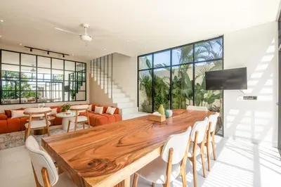 a dining room with a large wooden table and chairs at Marvelous 6BR 2 mins to Beach in Canggu