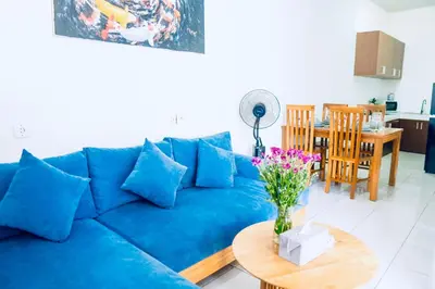 a blue couch in a living room with a table at Villa Majegau 4 Seminyak in Seminyak