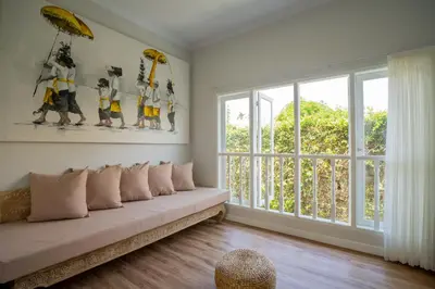 a living room with a couch and a large window at Deja Blu Villa in Seminyak