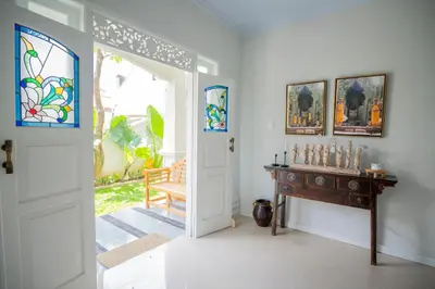 a room with a door and a table with a stained glass window at Deja Blu Villa in Seminyak