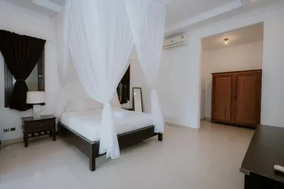 a bedroom with a bed with a canopy at Villa Bali 2X in Canggu