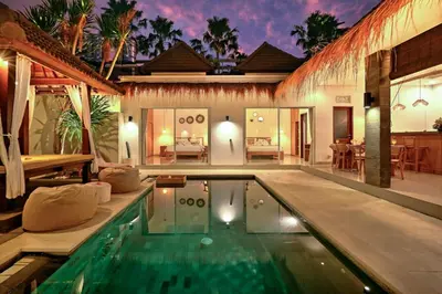 a villa with a swimming pool and a house at Villa Esha II in Seminyak