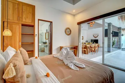 a bedroom with a bed with a towel animal on it at Villa Esha II in Seminyak