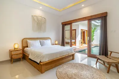 a bedroom with a large bed and a balcony at Sundaze 3 - Villa with Huge Pool and Kitchen in Canggu