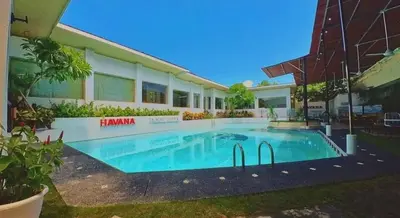 a swimming pool in front of a building at Privat Pool villa at kuta in Kuta