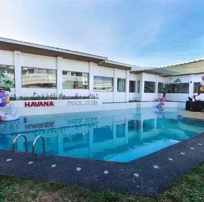 a large swimming pool in front of a building at Privat Pool villa at kuta in Kuta