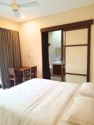 a hotel room with a bed and a table at Dana Villa Bali in Seminyak