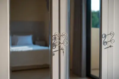 a glass door to a bedroom with a bed at Villa Uma Sari in Kerobokan