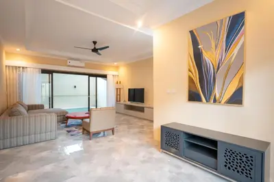 a living room with a couch and a tv at Villa Uma Sari in Kerobokan