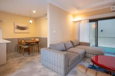 a living room with a couch and a table at Villa Uma Sari in Kerobokan