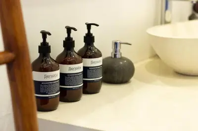 a group of four bottles sitting on a bathroom counter at Boho-chic Canggu Villa near Cafè Del Mar, 5-minute walk to beach in Canggu