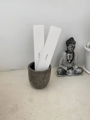 a small statue of a buddha sitting next to a vase at Boho-chic Canggu Villa near Cafè Del Mar, 5-minute walk to beach in Canggu