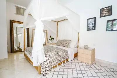 a bedroom with a bed with a canopy at Boho-chic Canggu Villa near Cafè Del Mar, 5-minute walk to beach in Canggu
