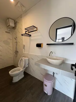 a bathroom with a sink and a toilet and a mirror at Uger House Seminyak in Seminyak