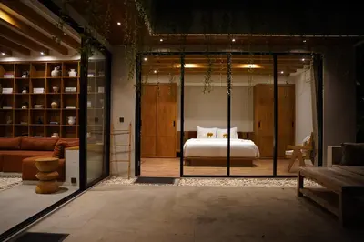 a bedroom with a bed in a room with glass doors at The Urban Retreat Seminyak Private Pool Villas with Butler for Families & Groups in Seminyak