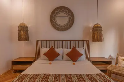a bedroom with a bed with a mirror on the wall at Cozy 2 beds villa in Seminyak in Seminyak