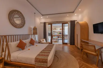 a bedroom with a bed and a desk and a television at Cozy 2 beds villa in Seminyak in Seminyak