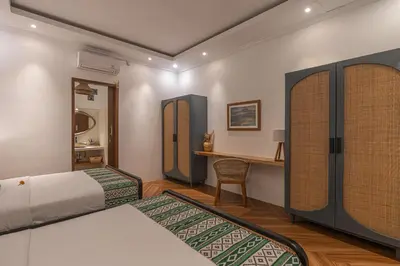 a bedroom with two beds and a desk in it at Cozy 2 beds villa in Seminyak in Seminyak