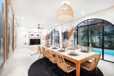 a dining room with a long table and chairs at Villa Sugi Umalas in Canggu